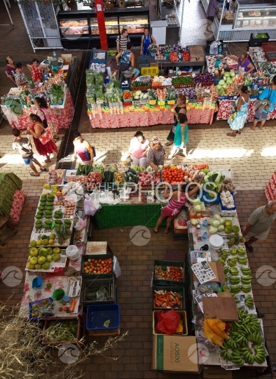 Market of Papeete, lady selling vegetables and fruits to people