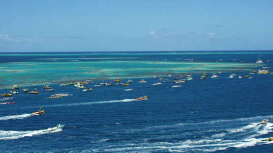 Raiatea, aerial view of the motor boat following the Hawaikinui paddle race
