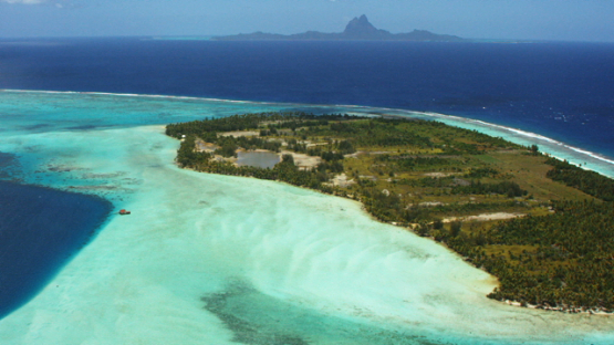 Tahaa, aerial view of the lagoon, and island of Bora Bora in the distance