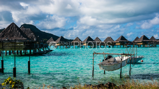 Overwater bunglaows of luxury hotel on Bora Bora Lagoon