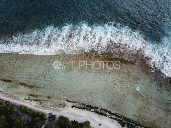 Vertical Aerial shot of thereef and shore of Tikehau