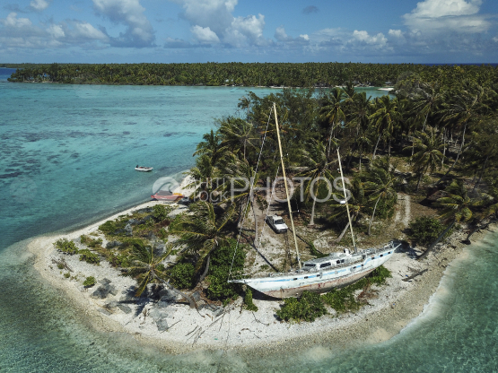 Rangiroa, aerial shot of a wreck of sail boat laid on the island