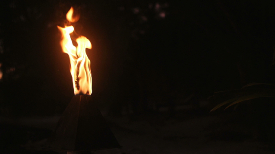 Bora Bora, flame on torch burning on the beach, slow motion