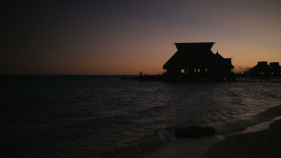 Bora Bora, view of luxury hotel during the sunset, by the lagoon, slow motion