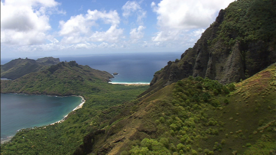 Aerial view of Nuku Hiva, over the village of Hatiheu along the rocky  mountain