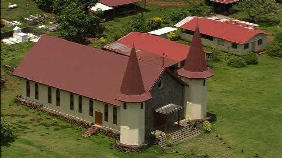 Aerial view of Nuku Hiva, zoom on church of Hatiheu