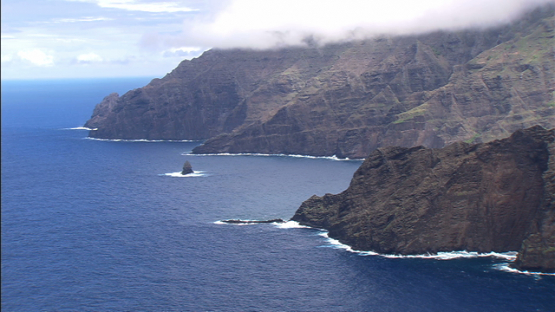Aerial footage of the rocky coast of Tahuata and ocean, Marquesas islands