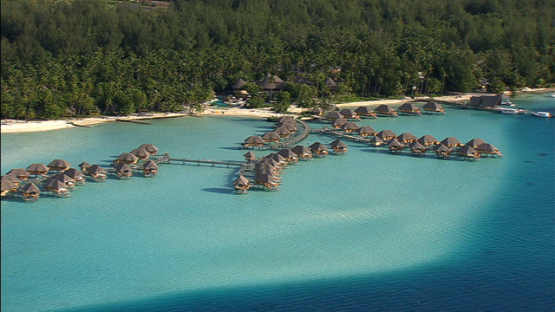 Aerial view of a luxury hotel and overwater bungalows in the lagoon of Bora Bora, Leeward islands