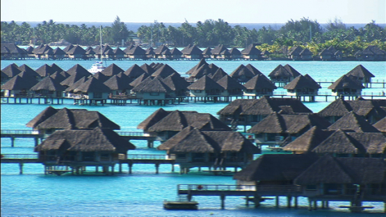 Aerial view of luxury hotels and overwater bungalows in the lagoon of Bora Bora, Leeward islands