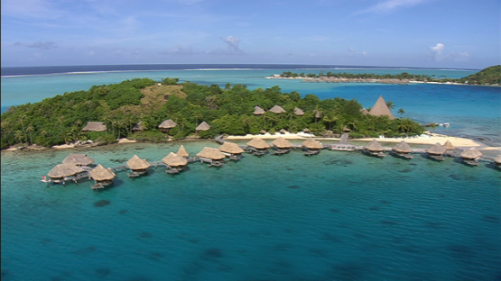 Aerial view of a luxury hotel and overwater bungalows in the lagoon of Bora Bora, Leeward islands