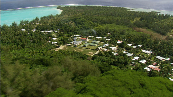 Village of Maiao behind the hill, aerial view, windward islands