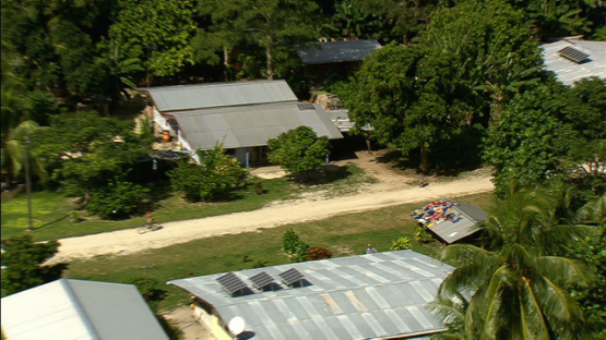 Village of Maiao and laundry drying on the roof, aerial view, windward islands