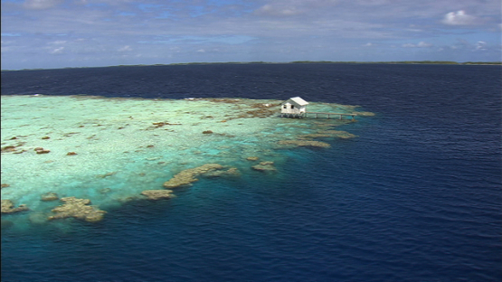 Ahe, aerial view of an overwater pearl farm in the lagoon, Tuamotu archipelago