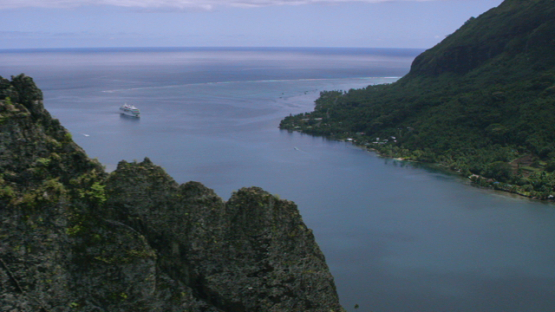 Moorea, aerial view of a cruise ship anchored in the Opunohu Bay, windward islands, 4K UHD