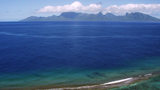 Aerial view of Moorea from over the barrier reef, windward islands, 4K UHD