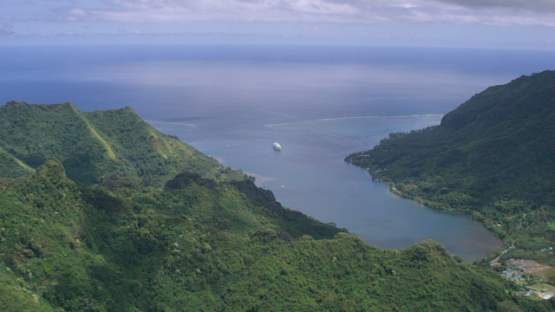 Moorea, aerial view of a cruise ship in Opunohu Bay, windward islands, 4K UHD