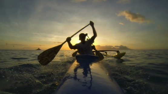 Tahiti, paddlers training in the lagoon on their tahiti canoe during sunset