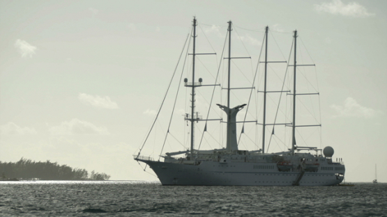 Four masts modern cruise ship anchored in the lagoon, Bora Bora, windward islands