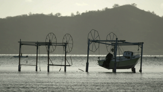 motor boat suspended by hoists in the lagon, bora bora, windward islands