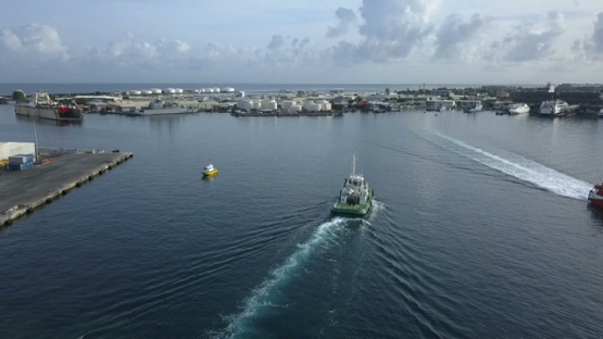Tahiti, tug boat in the port of Papeete, aerial video drone