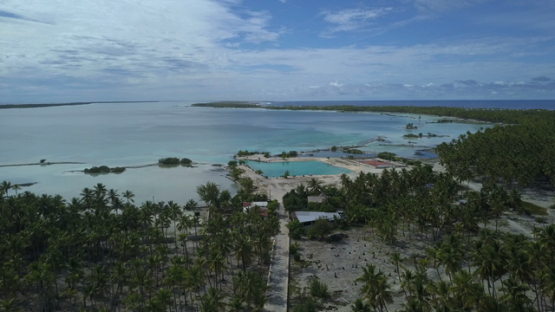 Reao, aerial drone shot  of the village and lagoon, Tuamotu, Polynesia 4K UHD