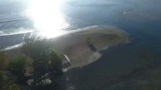 Aerial video by drone of the black sand beach of Pointe Venus, Tahiti, Polynesia