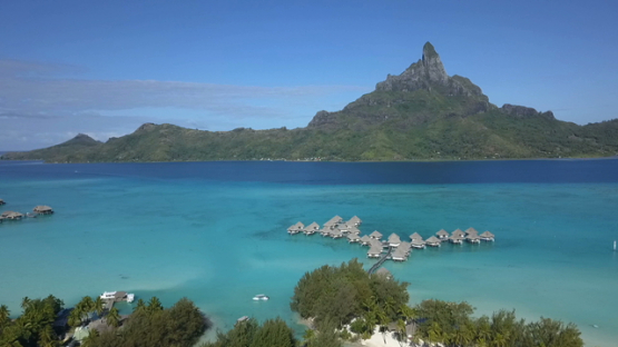 Bora Bora, aerial drone video of a luxury overwater hotel in the lagoon, leeward islands, polynesia