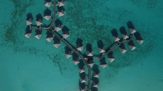 Bora Bora, aerial drone video above a luxury overwater hotel in the lagoon, leeward islands, polynesia