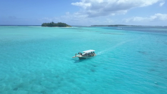 Bora Bora, aerial drone video, outrigger boat in the lagoon,  leeward islands, Polynesia