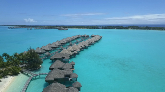 Bora Bora, aerial drone video of luxury overwater hotel in the lagoon, leeward island, polynesia
