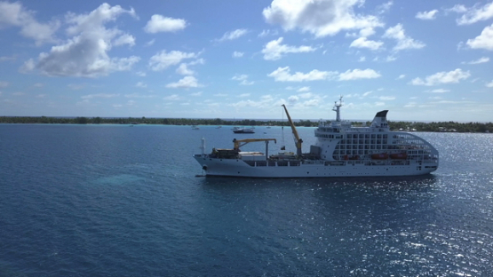 Bora Bora, aerial drone video of cargo cruise ship moored in the lagoon, leeward island, polynesia 4K UHD