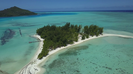 Bora Bora, aerial drone video of a private island and white sand beach in the lagoon, leeward island, polynesia 4K UHD