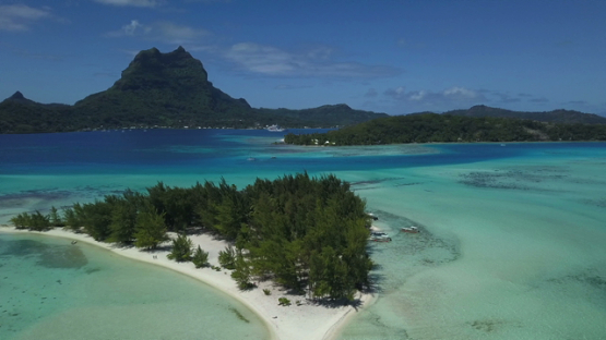 Bora Bora, aerial drone video of a small island in the lagoon, leeward island, polynesia 4K UHD
