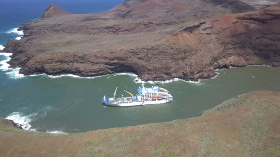 Ua Huka, aerial drone video of cargo cruise ship anchored in the bay, marquesas islands, polynesia, 4K UHD