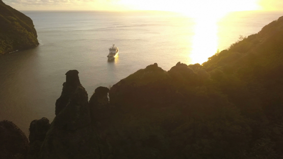 Fatu Hiva, aerial drone video of cruise ship anchored in the Virgins bay, Marquesas islands, Polynesia, 4K UHD