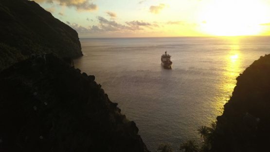 Fatu Hiva, aerial drone video of cruise ship anchored, Hanavave bay, Marquesas islands, Polynesia, 4K UHD