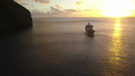Fatu Hiva, aerial drone video of cruise ship anchored in Hanavave bay, Marquesas islands, Polynesia, 4K UHD