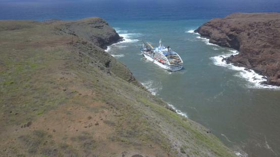 Ua Huka, aerial drone video, cargo anchored in the bay Vaipaee, marquesas islands, Polynesia 4K UHD