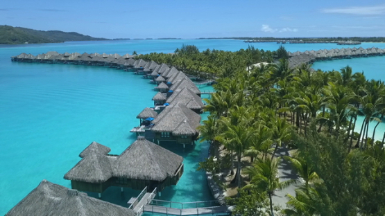 Bora Bora, aerial drone video over luxury overwater hotel in the lagoon, leeward island, polynesia