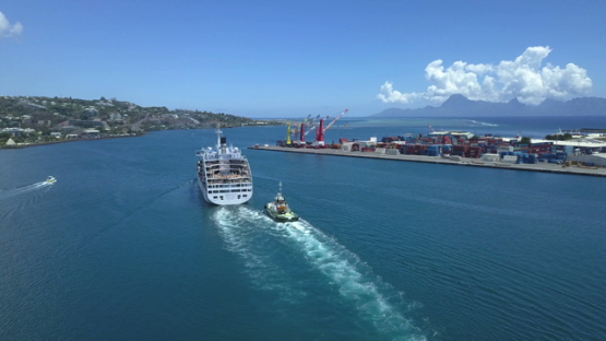 Papeete Harbour, aerial drone video of cruise ship and tug boat in the bay, Tahiti Polynesia 4K UHD