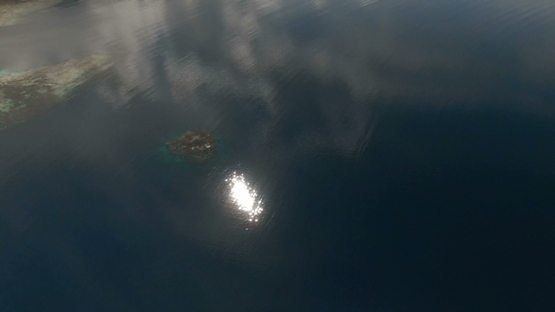 Tahiti, aerial drone view of sun reflection on the lagoon, Vairao