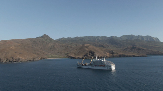 Aerial drone view, Cargo cruise ship moored in the bay, Marquesas islands, Polynesia, 2K7