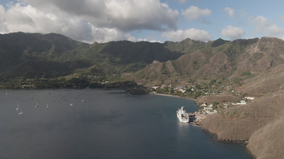 Aerial drone view of Nuku Hiva, Cruise cargo ship at the pier of Taiohae, Marquesas islands, 2K7