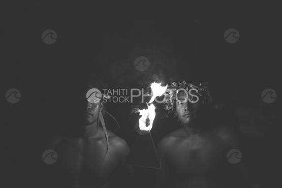 BORA BORA, PORTRAIT OF POLYNESIAN MEN WITH FIRE TORCH AT NIGHT