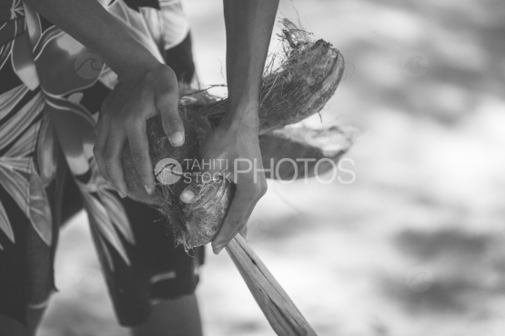 Polynesian man breaking  a coconut, Bora Bora