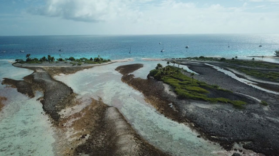 Aerial view by drone over the barrier reef toward the lagoon, 4K UHD