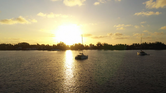 Aerial view of Fakarava, sunset and Sail boats in the lagoon, 4K UHD aerial view