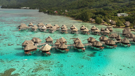 Aerial Drone shot of overwater bungalows in the lagoon, Moorea, 4K UHD