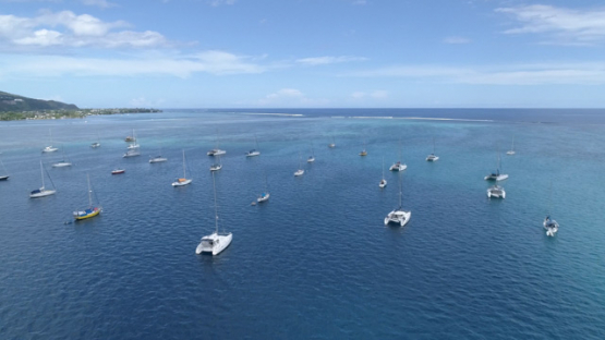 Aerial view of Tahiti, anchored sail boats in the lagoon of Punaauia, 4K UHD