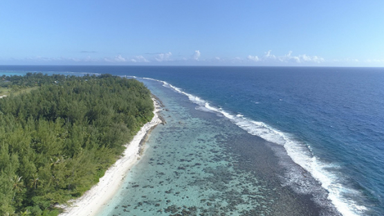 Moorea, aerial view of the barrier reef of Motu Temae, 4K UHD